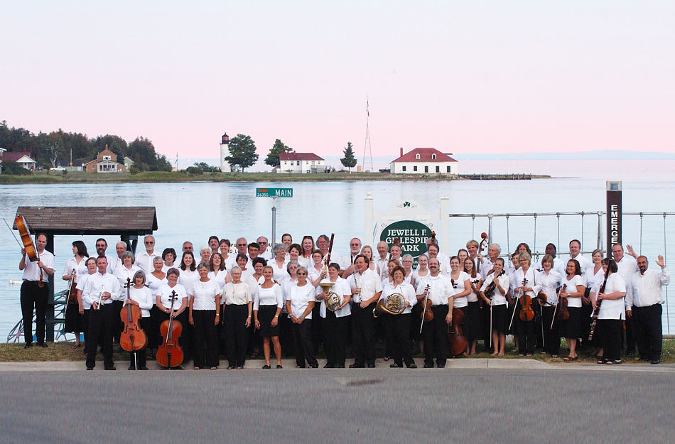 Baroque on Beaver Musicians pose in front of the Beaver Island Harbor