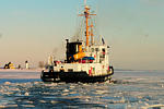 As onlookers watch from the dock, the Biscyane Bay coastguard cutter circles through the harbor slicing through the 16-inch blue ice