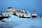 As a pile of ice chunks lays beside the dock, fished out with backhoe, the Emerald Isle nudges herself into the birth.